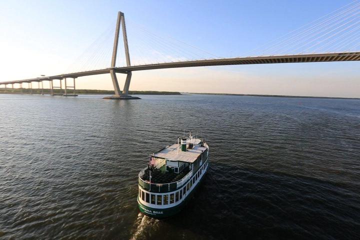 a boat traveling across a bridge over a body of water