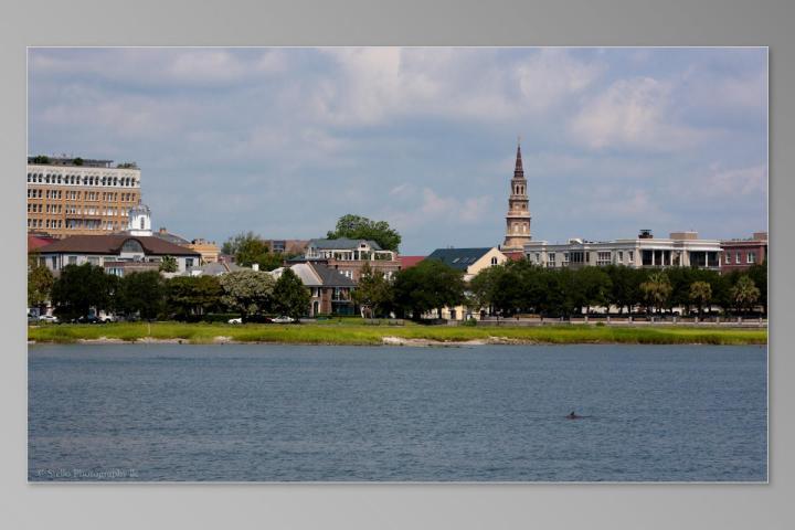 a large body of water with a city in the background