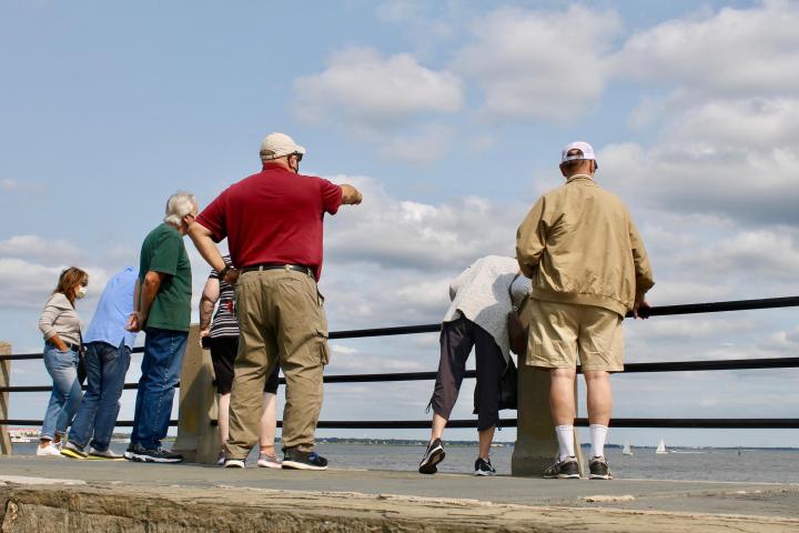 a group of people standing on a beach