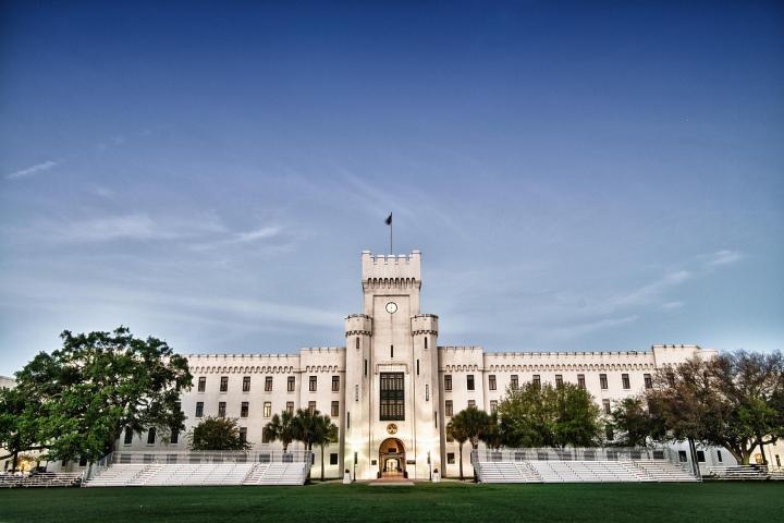 a large clock tower next to a body of water